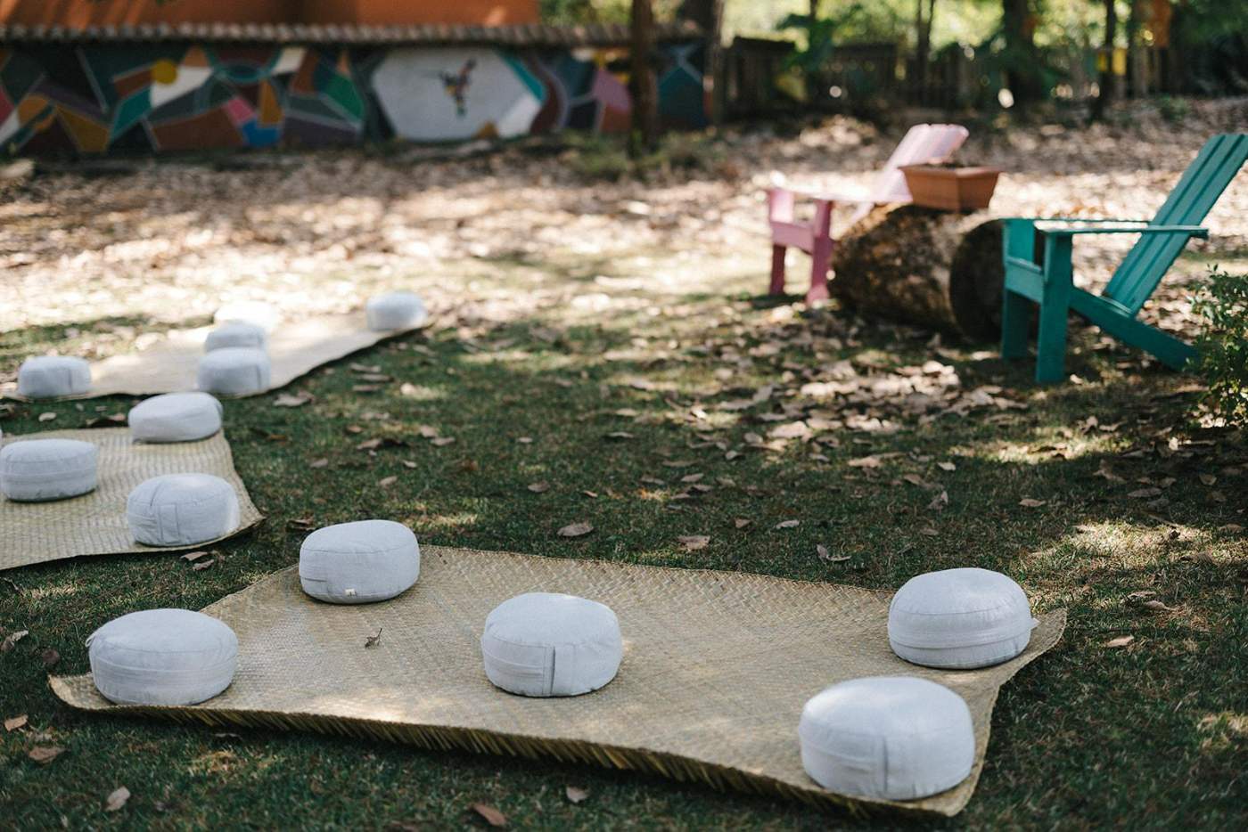 Cojines y petates dispuestos en el jardín para una sesión de LAB